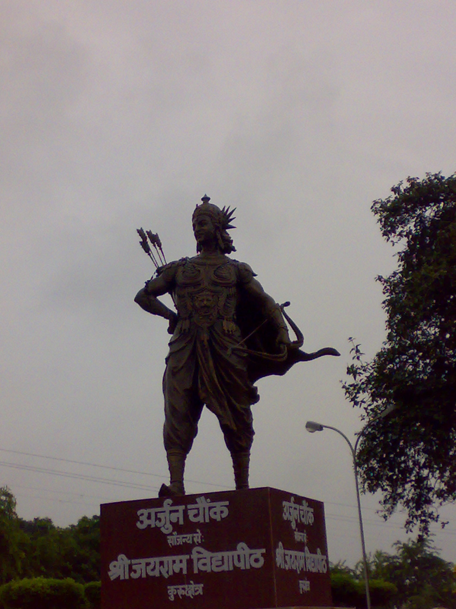 Arjuna Statue | Indian Press A statue of Arjuna with a bow stands at Arjun Chowk in Kurukshetra, India.