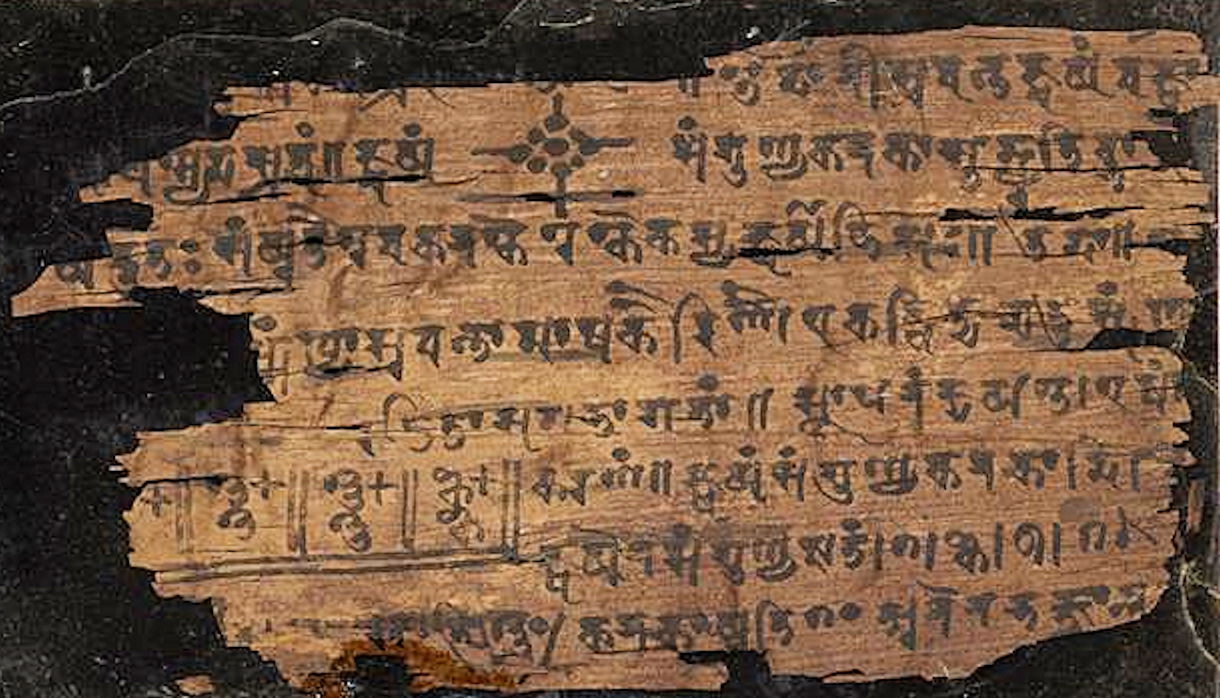 An ancient palm leaf manuscript displays faded writing, relating to Indian history and astronomy.