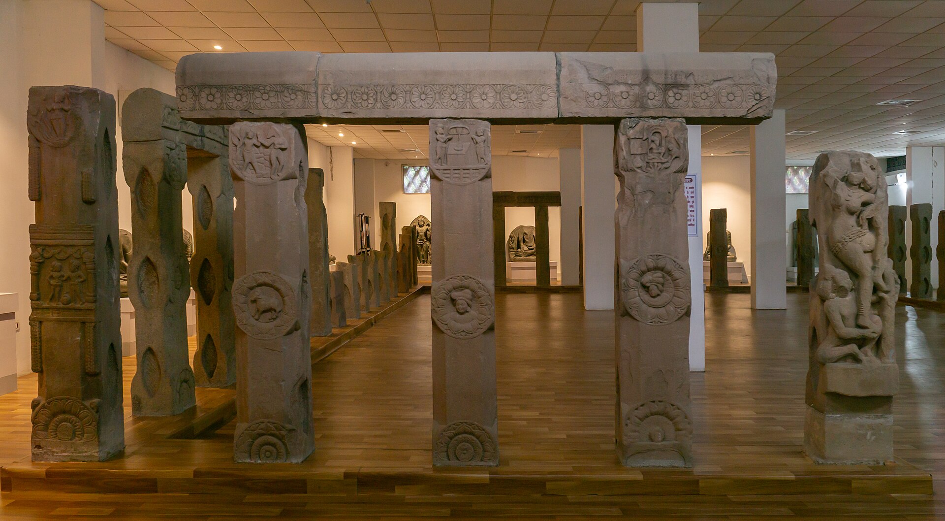 Buddhism History | Indian Press Ancient stone carvings detail a doorway structure in an archaeological museum, illustrating the history of Buddhism.