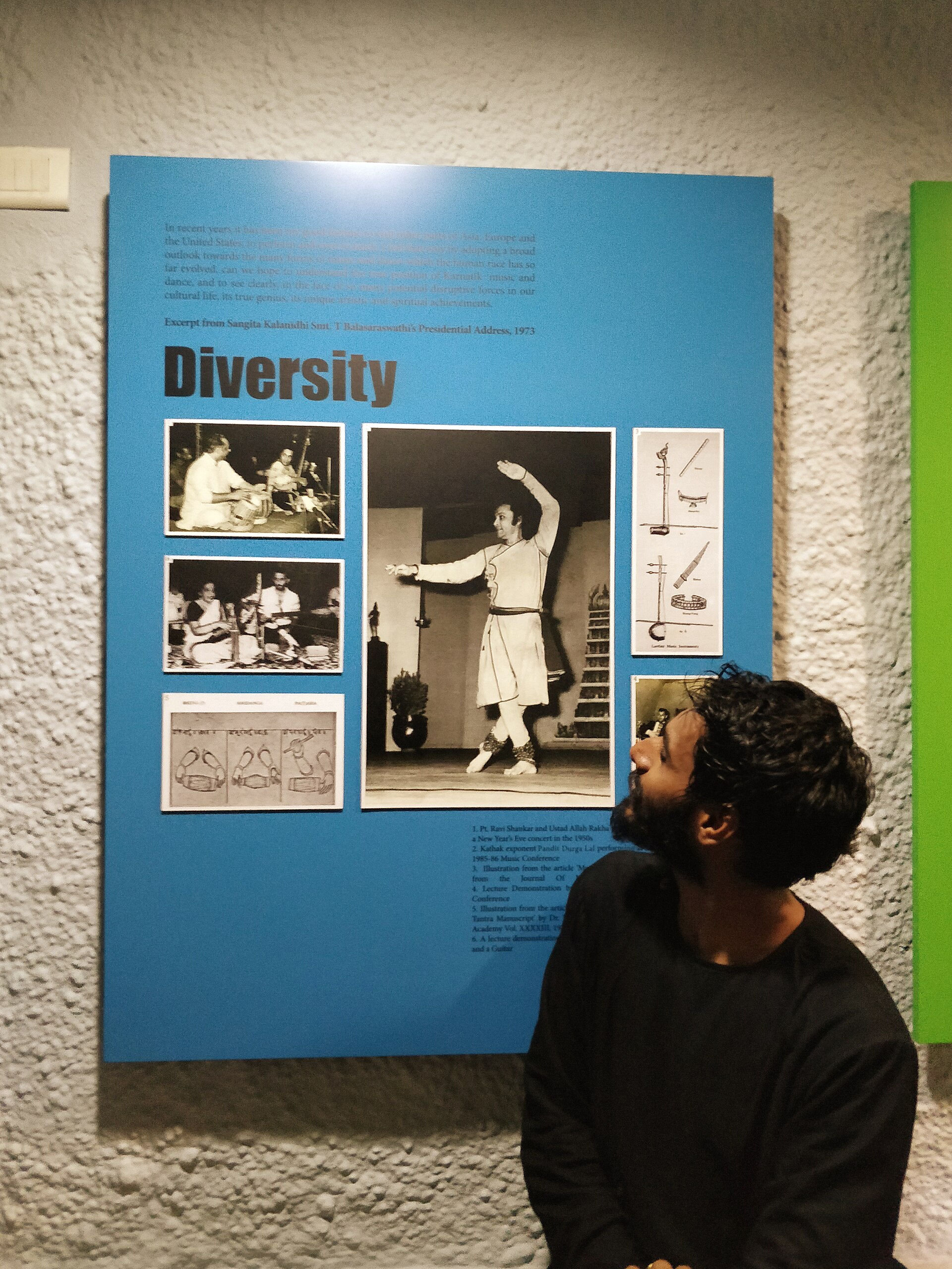 Diversity Exhibit | Indian Press A man looks at a museum exhibit about diversity featuring historical photographs.