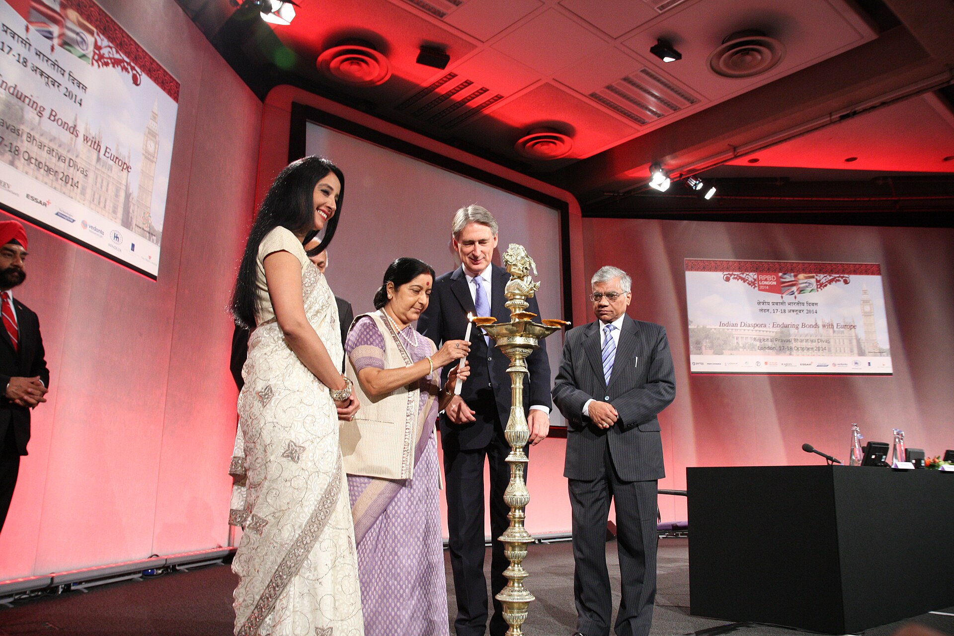 Diaspora Philanthropy | Indian Press People light a traditional lamp at an event celebrating cultural exchange and the Indian diaspora.