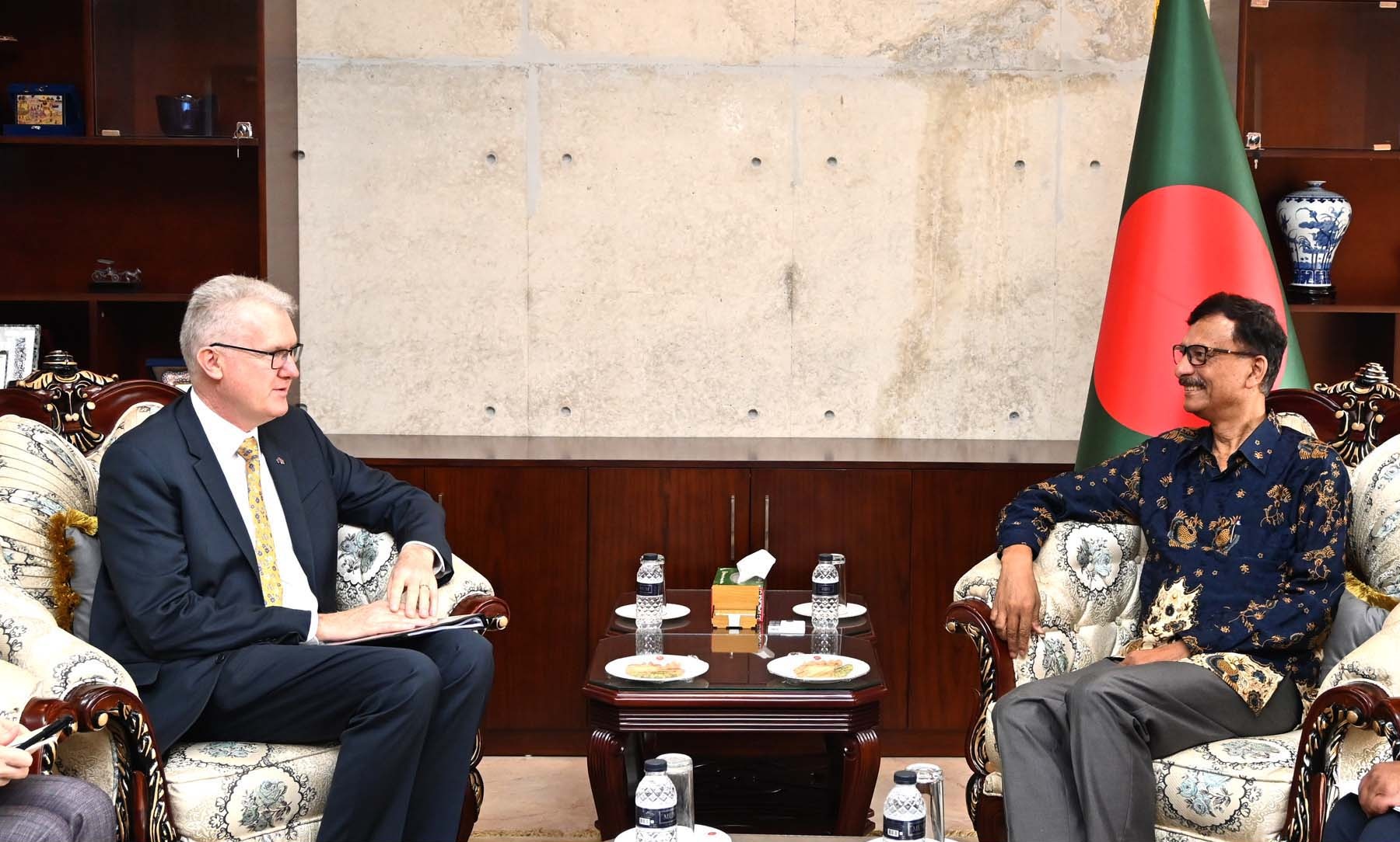 Two men are seated in a formal meeting, discussing international relations and diplomacy.