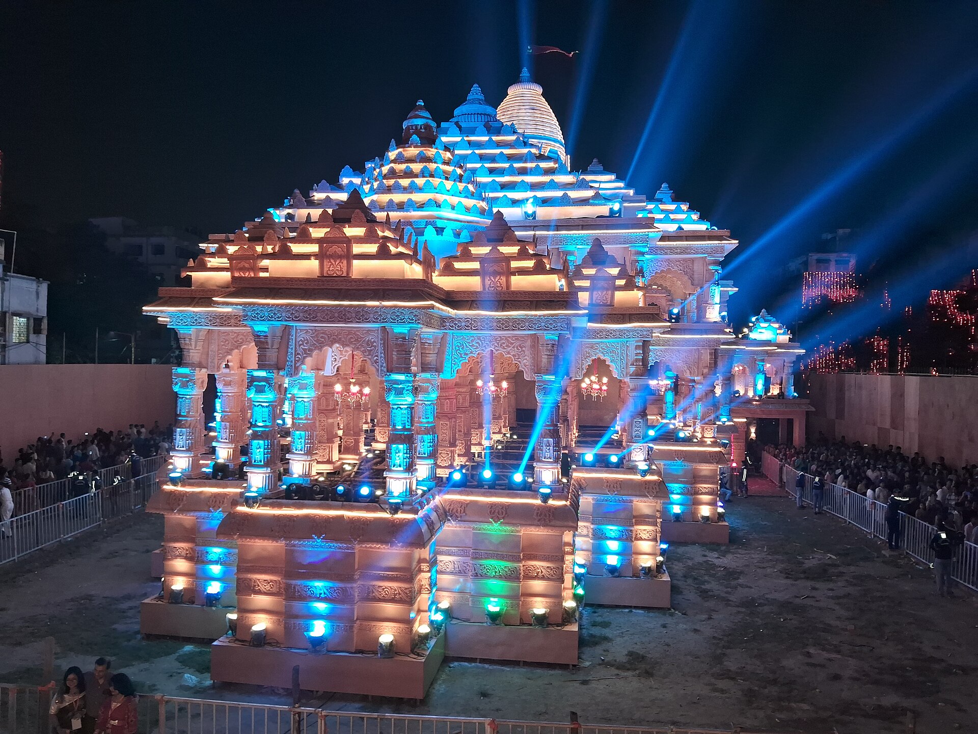 An illuminated Durga Puja pandal in Kolkata draws crowds during the festival, celebrating Indian culture.