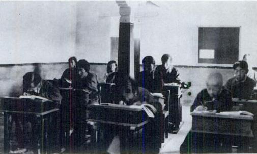 Early Classroom | Indian Press Students are in a classroom during an early 20th-century lesson, showing education in India.