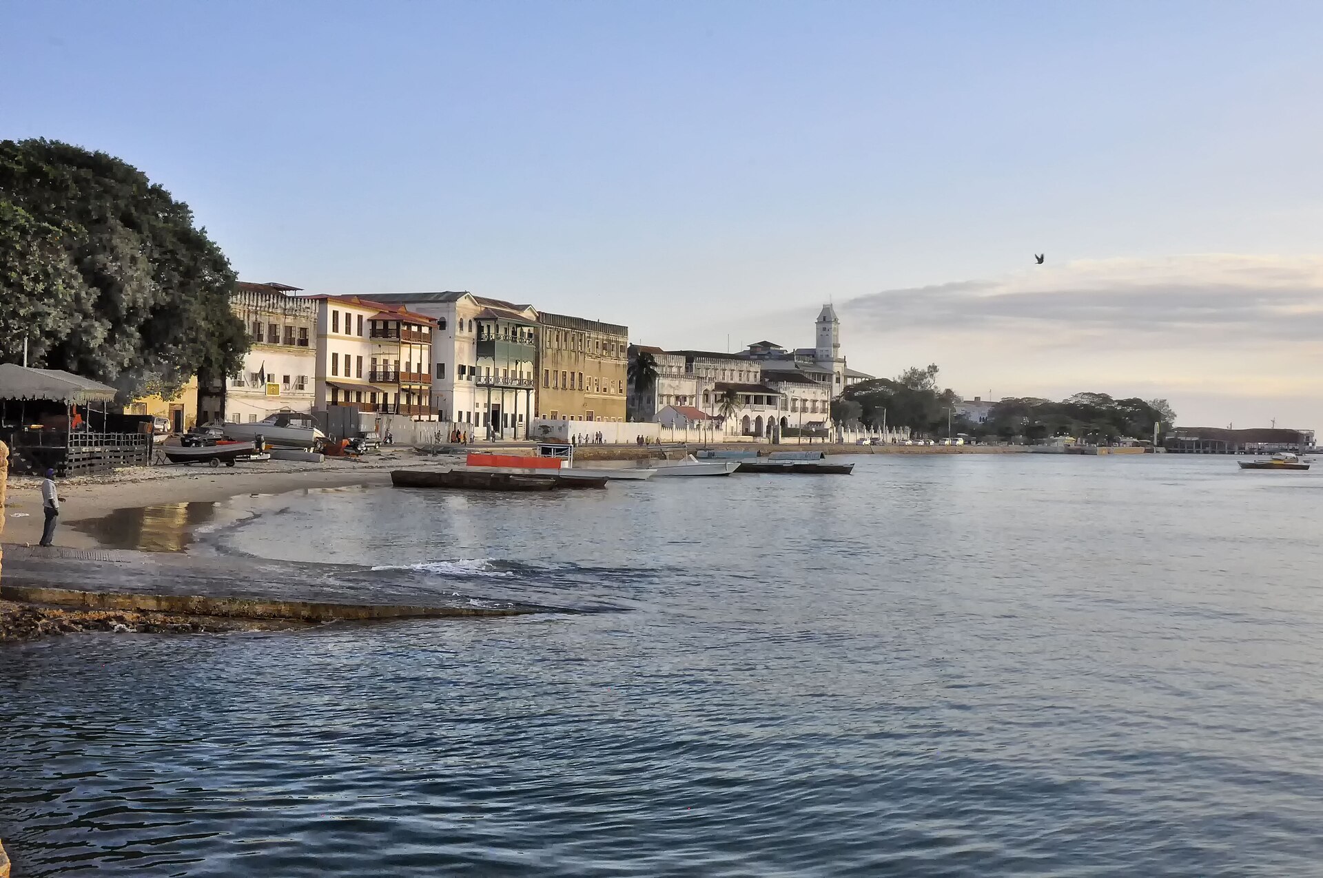 Stone Town's waterfront in Zanzibar shows historic buildings and boats along the coast, reflecting East Africa’s Indian.