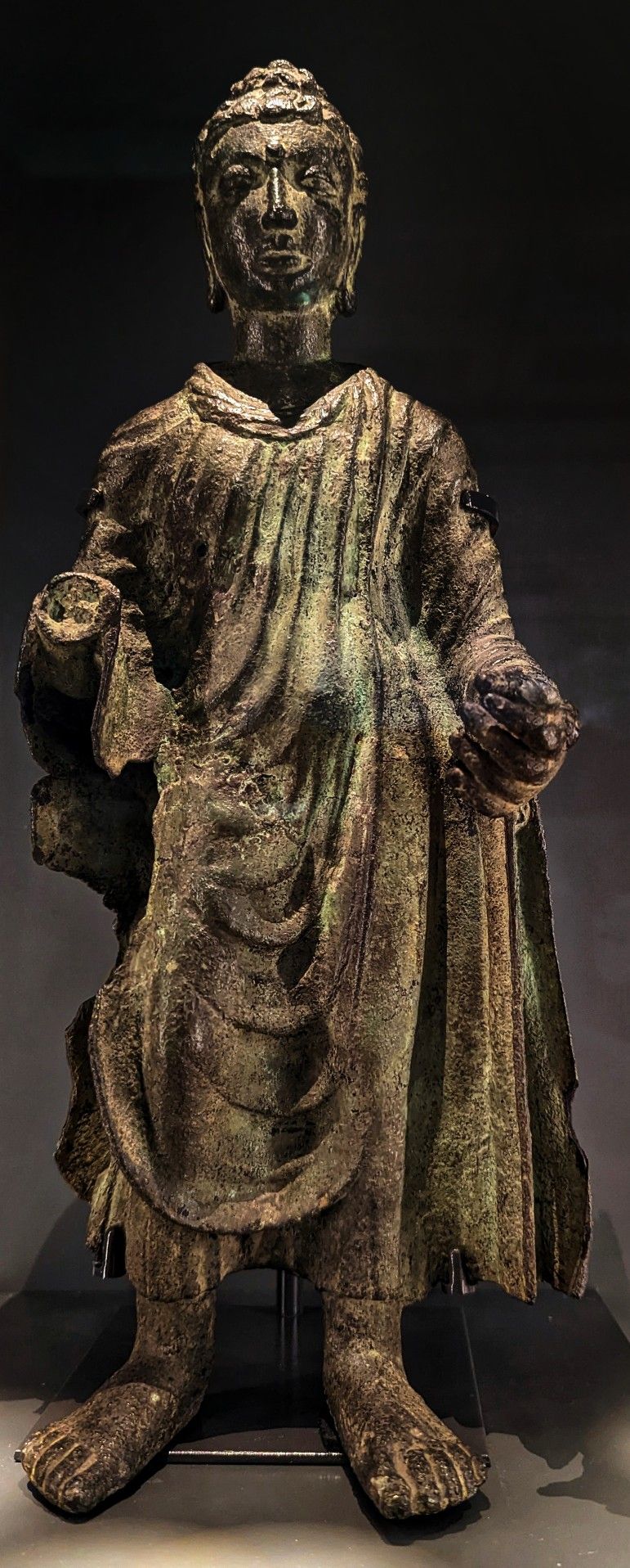 Gandhara Buddha | Indian Press A weathered bronze Buddha statue from the Gandhara school of art, representing ancient religious iconography.