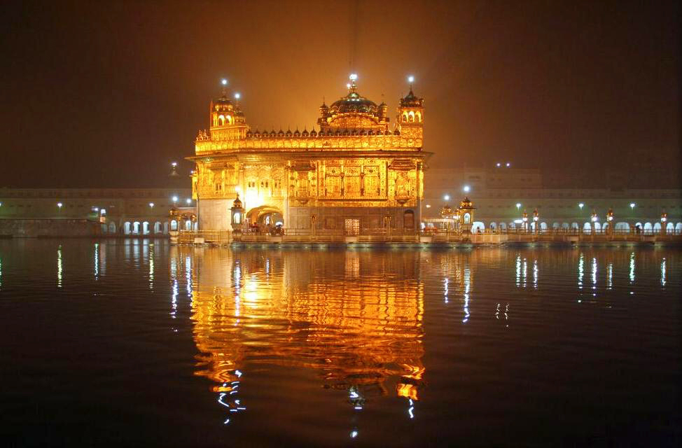 Golden Temple | Indian Press The Golden Temple in Amritsar glows at night, beautifully reflected in the water, showcasing Indian culture.