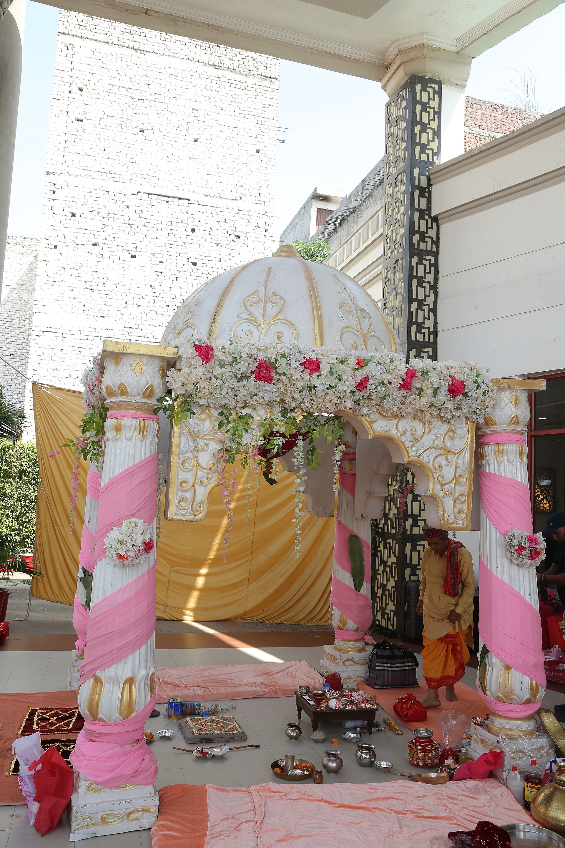 Hindu Wedding Mandap | Indian Press An ornate mandap decorated with flowers is prepared for a Hindu wedding ceremony, reflecting Indian culture.
