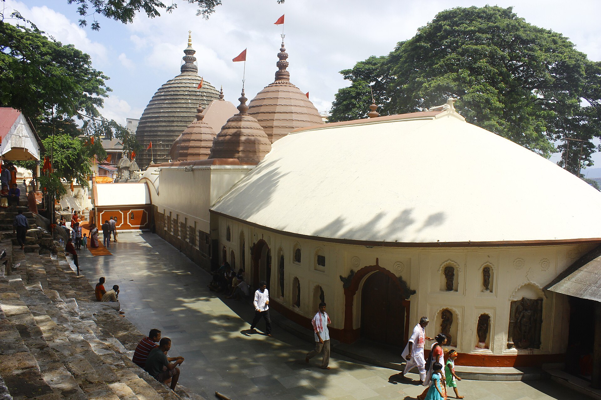 The Kamakhya Temple complex in Assam features multiple shrines with distinctive dome architecture, reflecting monsoon.