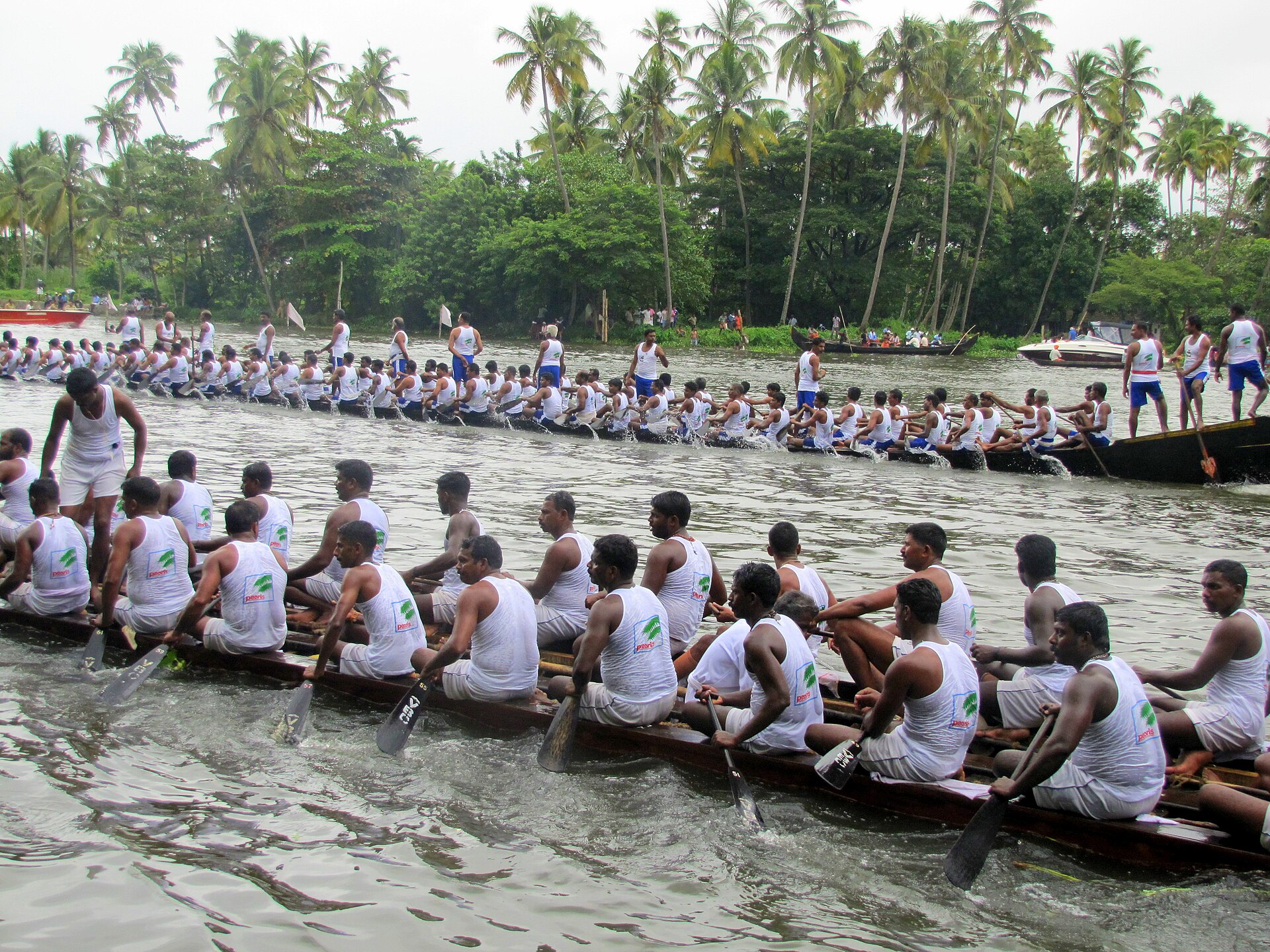 Onam Boat Race | Indian Press A snake boat race takes place on the water in Kerala, showcasing a vibrant cultural tradition.