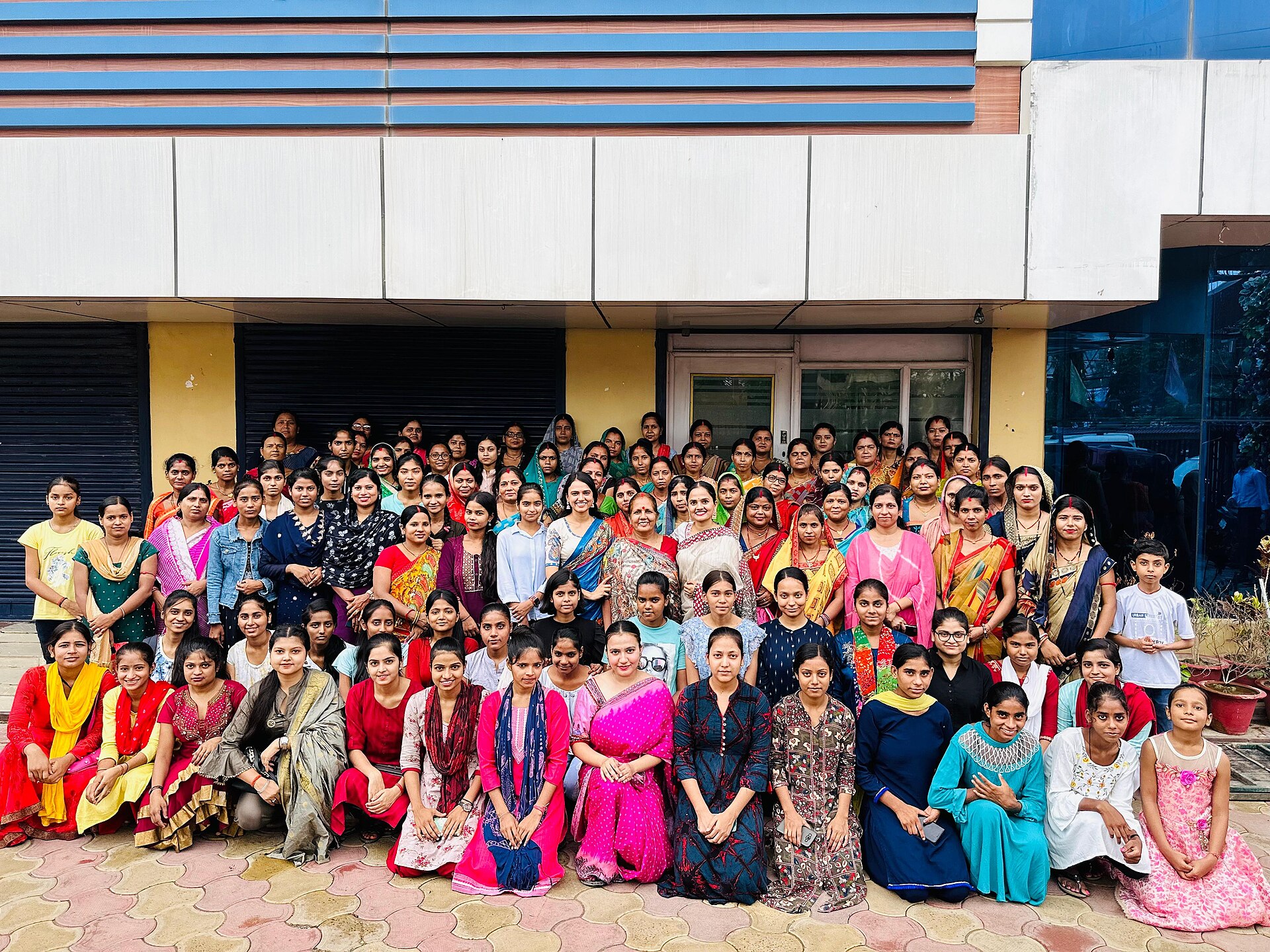 Asha Jha | Indian Press Asha Jha, a Madhubani painting artist, poses with girls and women in Bihar.
