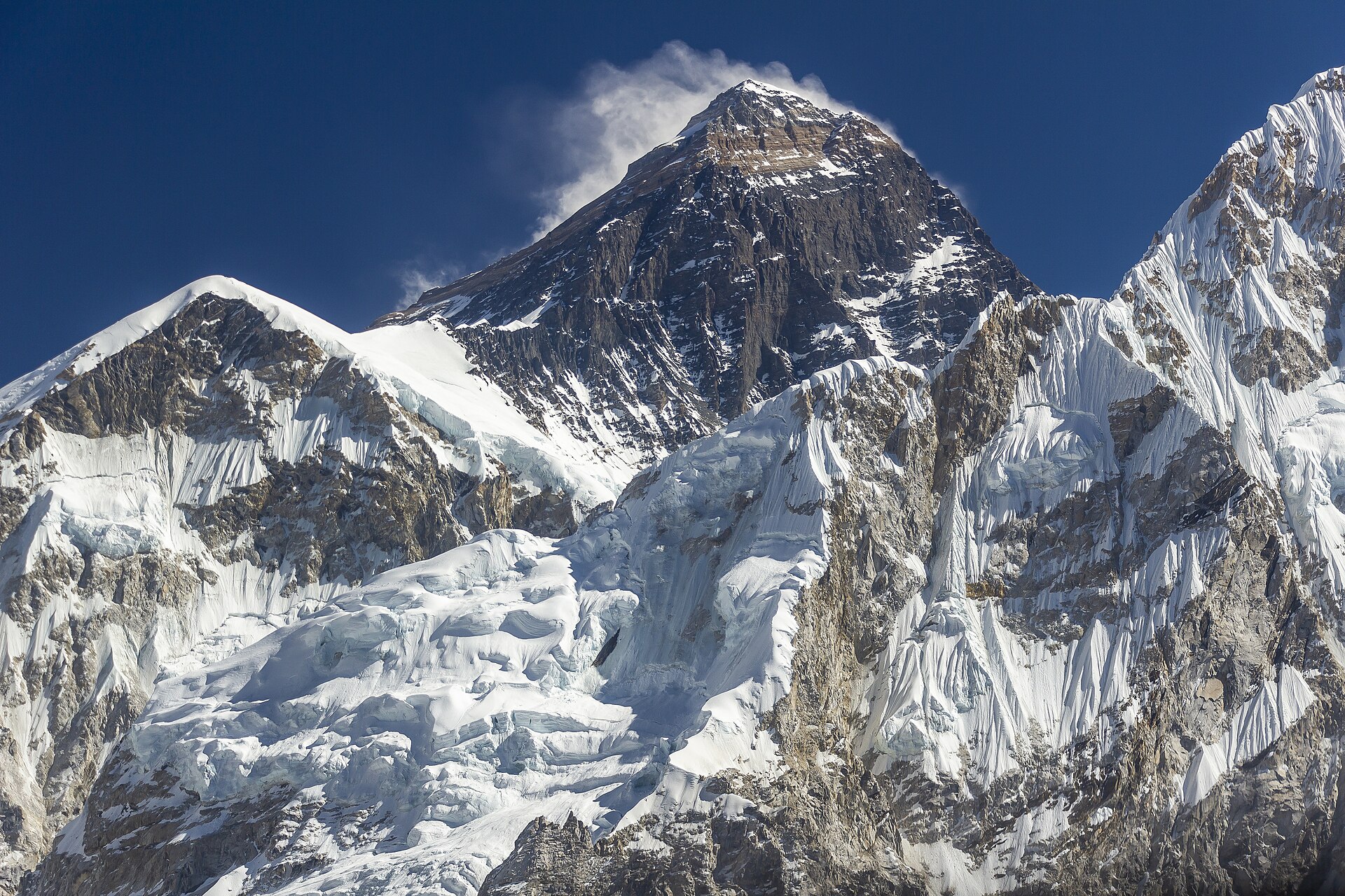 Mount Everest's peak rises above the Himalayas, showcasing a stunning landscape for Indian Press readers.