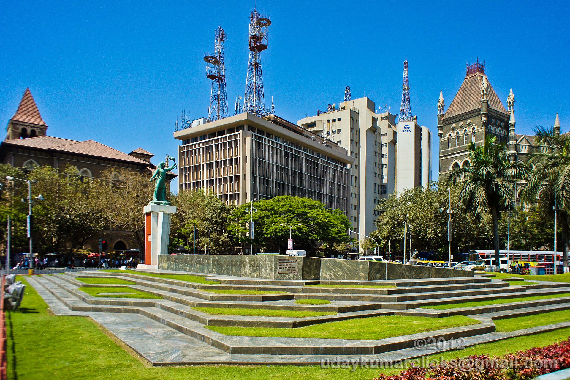 Mumbai’s Chhatrapati Shivaji Maharaj Terminus is shown with surrounding buildings on a sunny day, reflecting Indian culture.