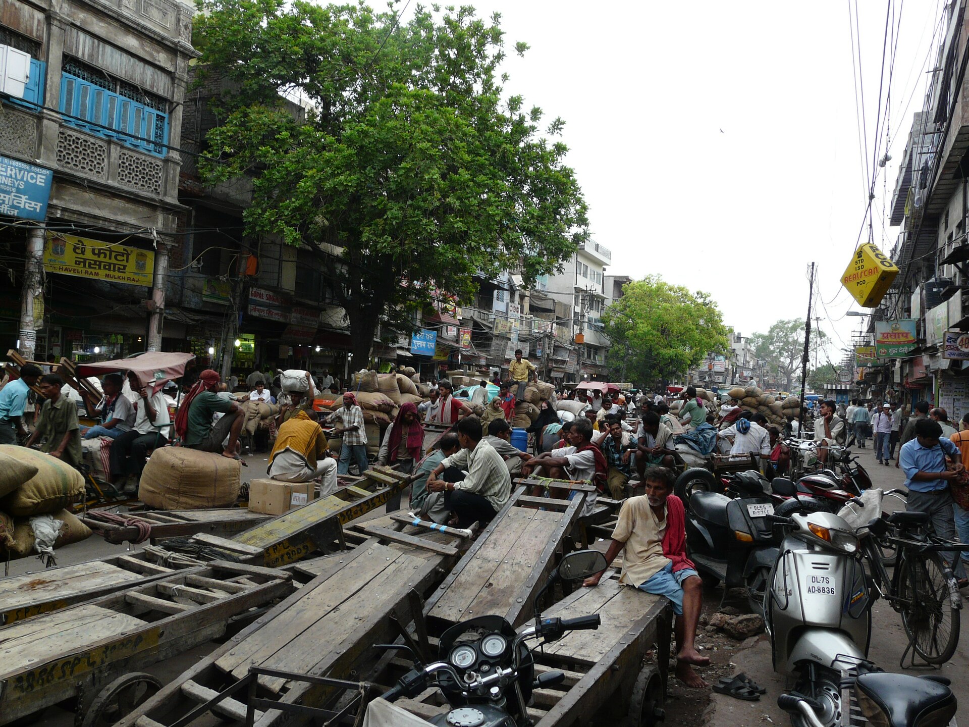 Old Delhi Spice Market | Indian Press A crowded street scene at the Spice Market in Old Delhi shows motorcycles and construction debris.