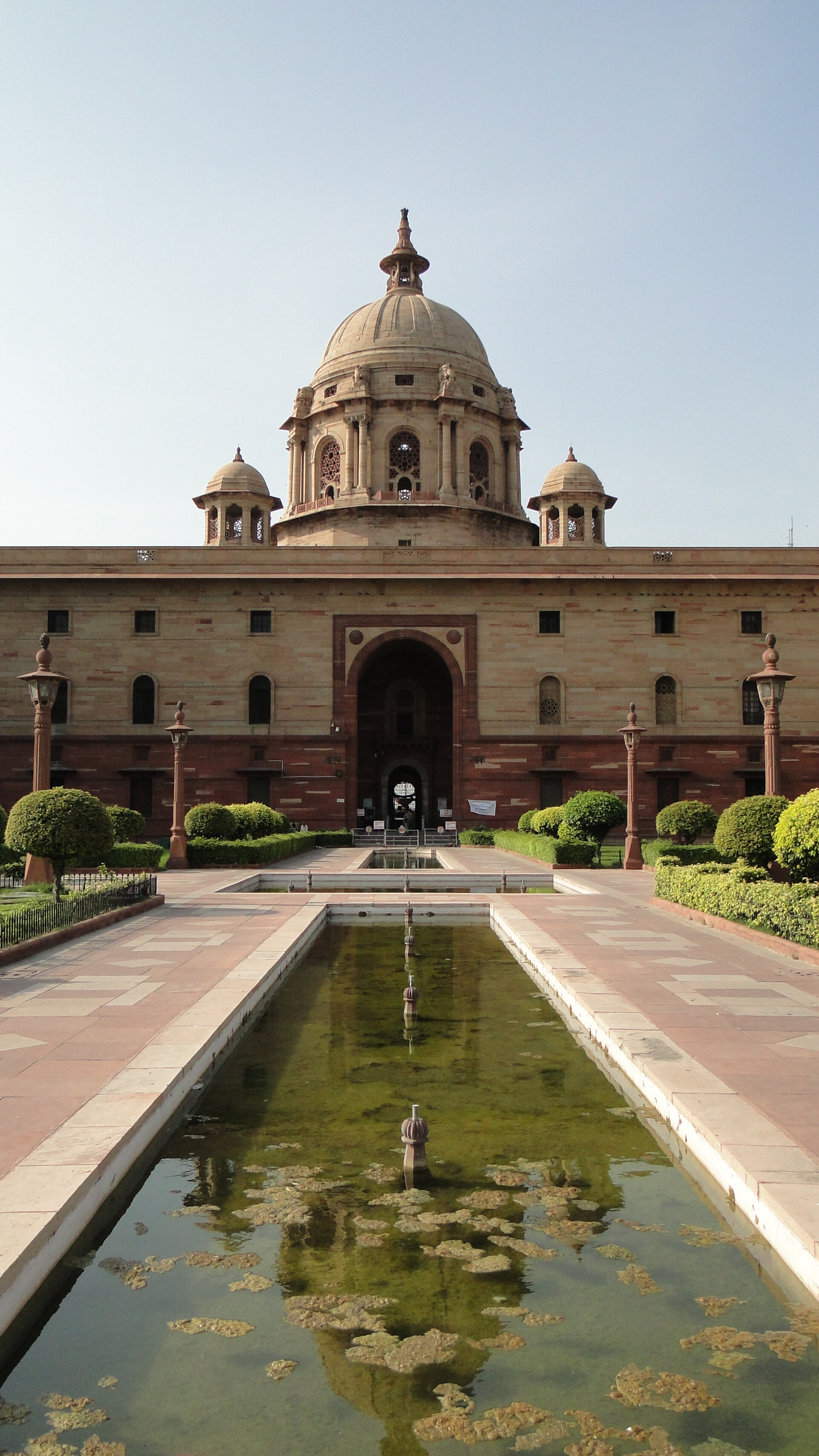 Rashtrapati Bhavan | Indian Press Rashtrapati Bhavan in New Delhi, India is pictured with a reflecting pool, showcasing Indian government architecture.