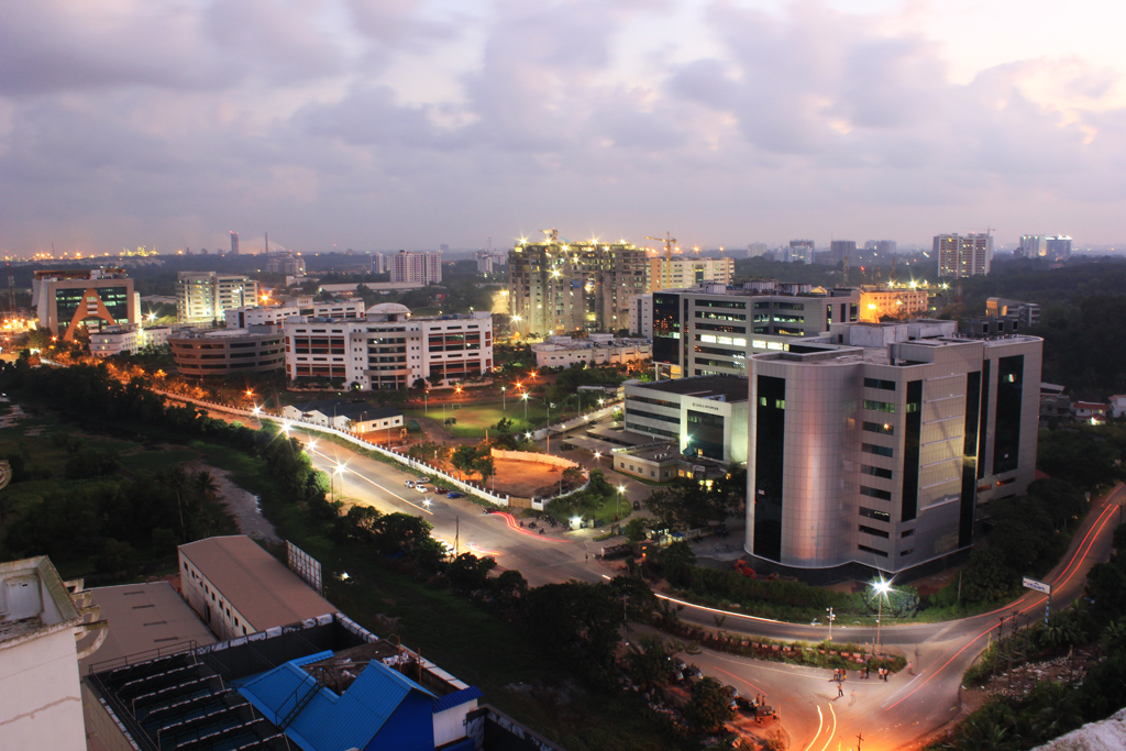 South Indian Tech Migration | Indian Press A nighttime cityscape shows modern buildings and illuminated streets relating to south Indian tech migration.